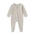 Sprout & Fawn The Sand Zip Sleeper in soft, neutral fabric, featuring a front zipper and cozy design for babies.
