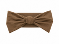 Sprout & Fawn bamboo bow headband in sandstone, featuring a soft fabric bow on a stretchy headband for baby or toddler.
